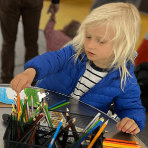 child at craft table